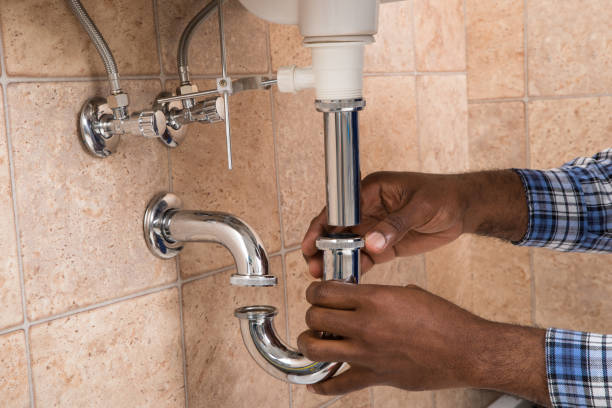 Plumber's hand fixing a sink